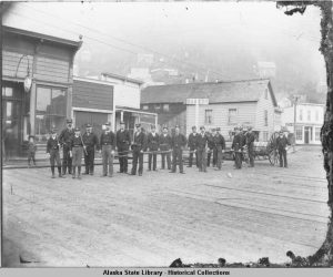 Juneau Fire Department on Front Street with hose cart, ca. 1890